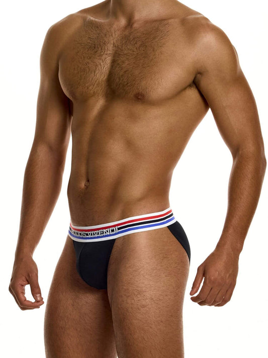 Man wearing a black tanga with a colorful striped waistband on a white background