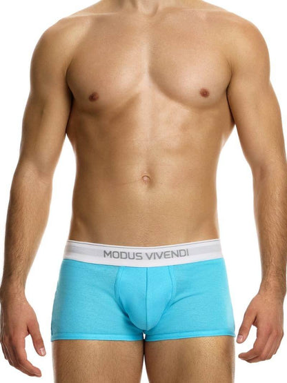 This image displays the MODUS VIVENDI Staple Boxer in a striking turquoise color, emphasizing its design features and fit. The boxer briefs are crafted from an eco-friendly cotton blend, including recycled yarns, supporting both sustainability and comfort.