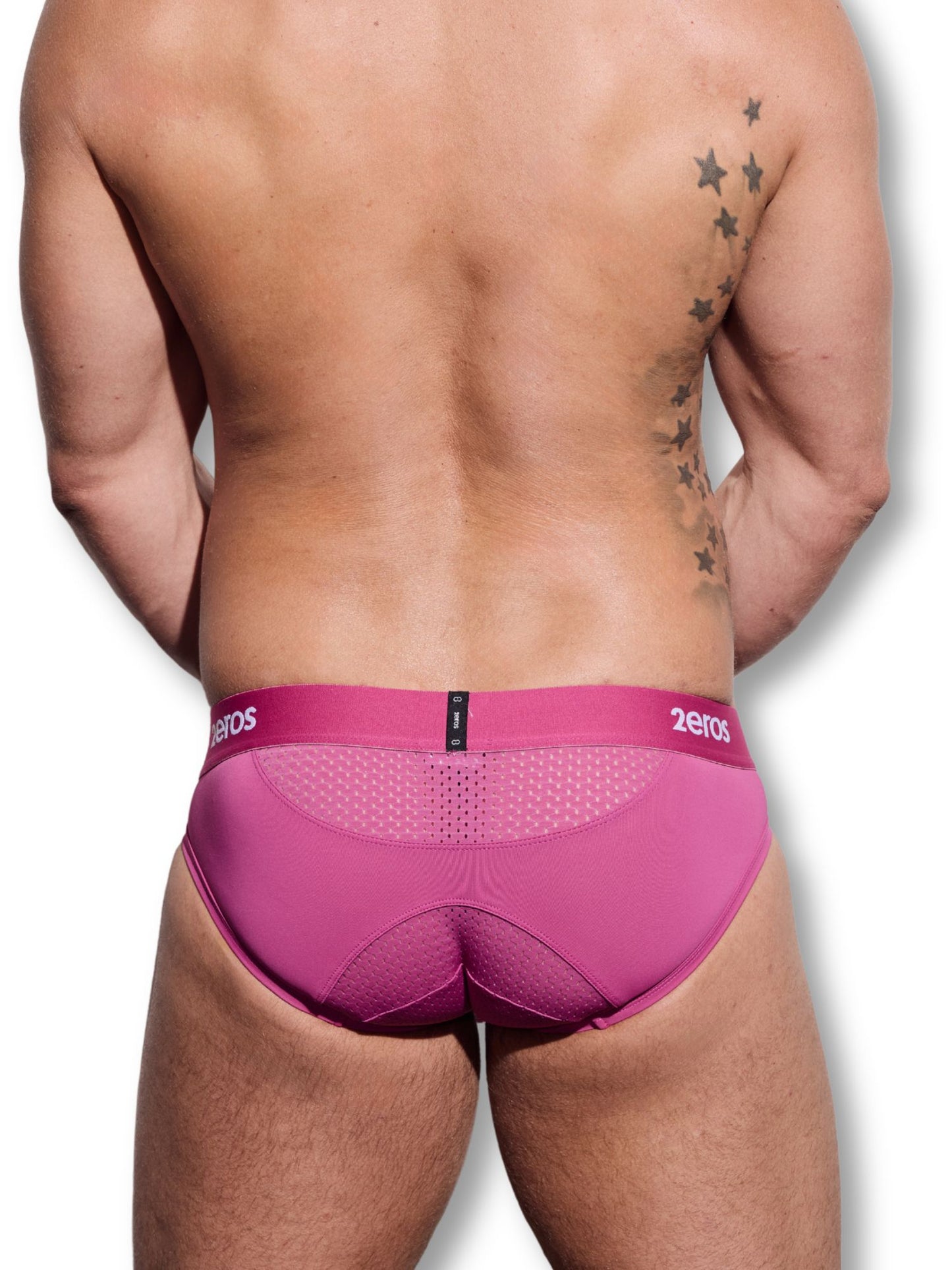 Person wearing a pink underwear with '2eros' branding on a white background