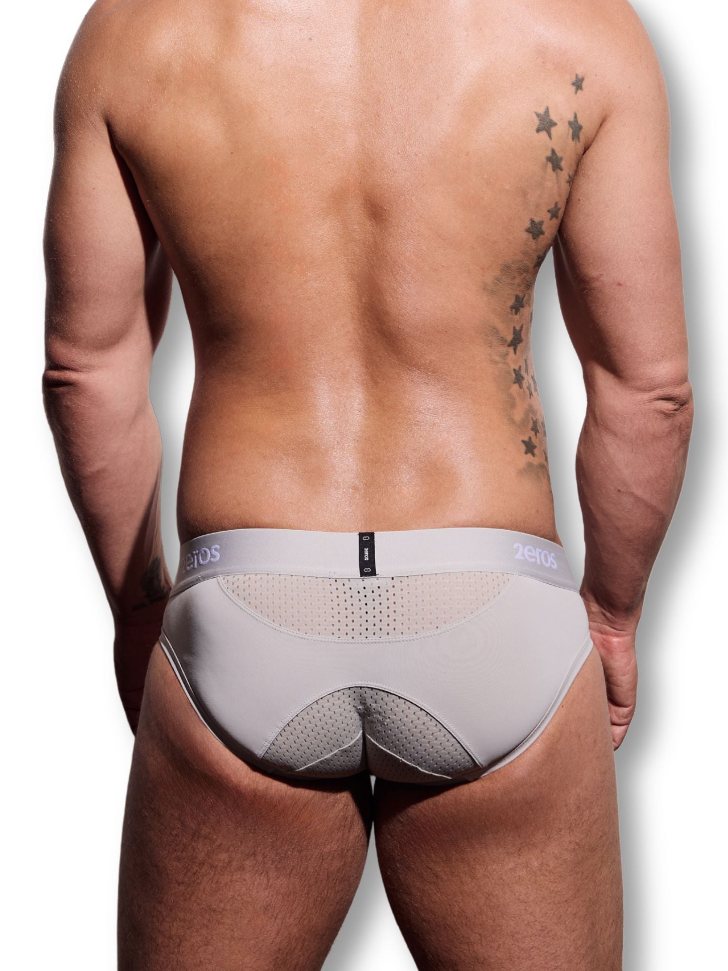 Man wearing grey underwear with a visible brand logo on a white background