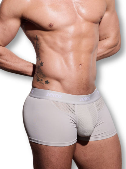 Man wearing a beige underwear with a visible brand logo on a white background