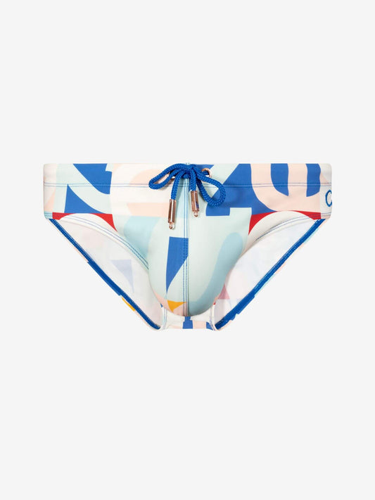 A pair of bikini bottoms featuring a colorful abstract geometric print with blue, pink, red, and light blue shapes on a white base. It has a blue drawstring waistband with gold-toned metal tips.
