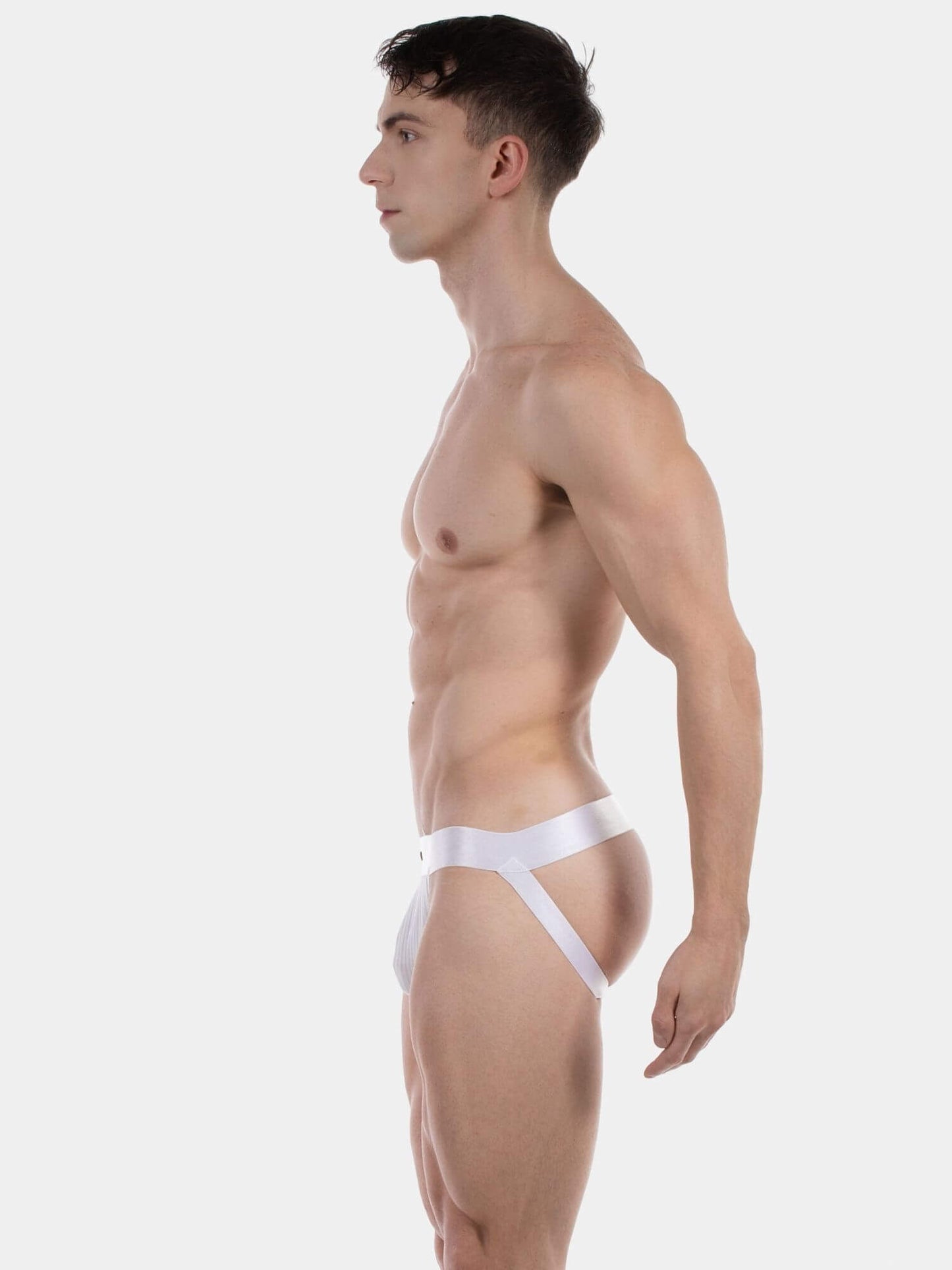 Man wearing a white men's underwear on a plain background