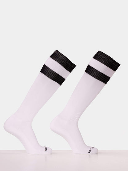 A pair of white knee-high athletic socks with two black horizontal stripes near the ribbed cuffs, displayed on invisible forms against a light gray background.