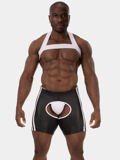 A muscular male model wearing black and white men's briefs with a white pouch insert and white side stripes, against a light gray studio background.