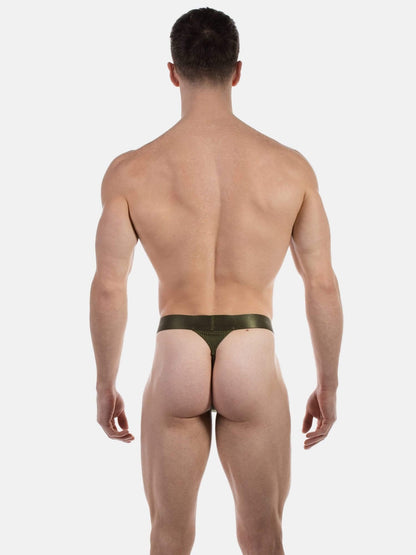 Rear view of a muscular man wearing a pair of dark olive green thong underwear against a light gray background.