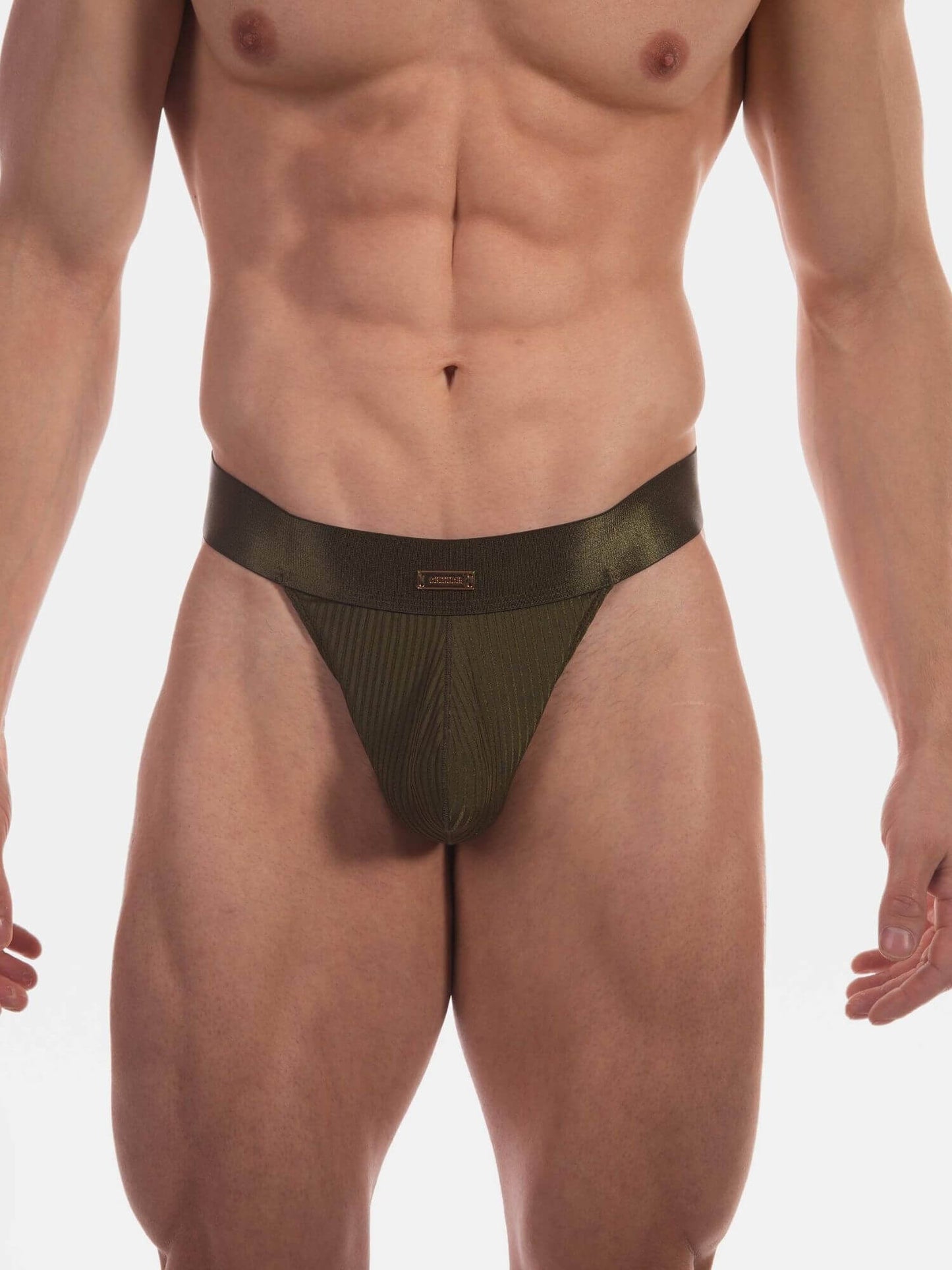 A close-up of a male model's lower torso wearing a low-rise, olive green satin thong with a ribbed front pouch and a small gold logo on the front center.