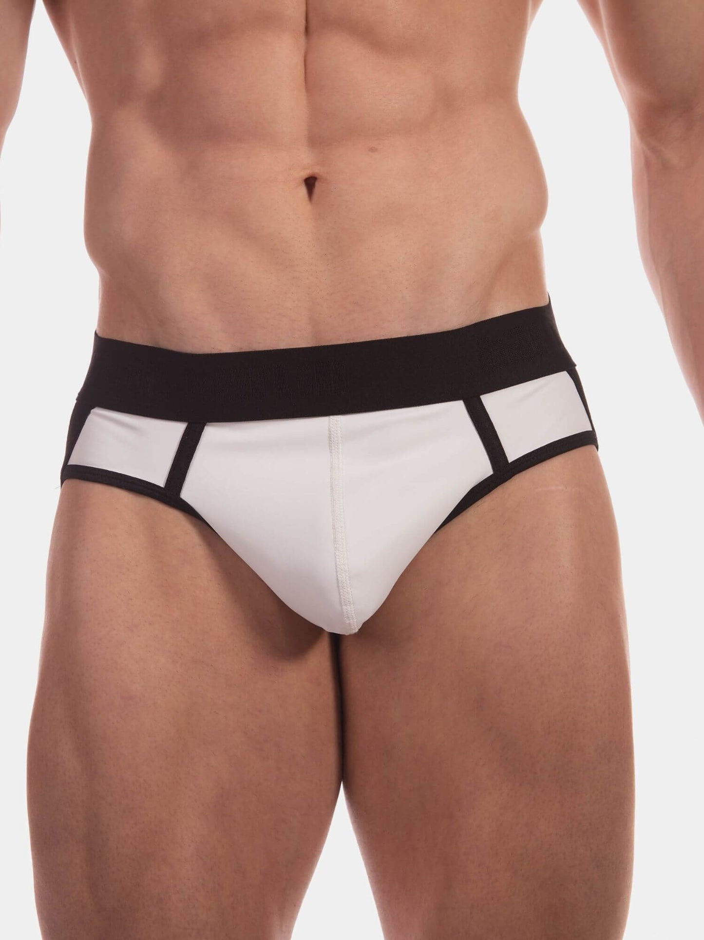 A close-up of a male model's lower torso wearing low-rise white jockstraps with a wide black waistband and black trim details.