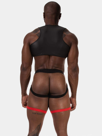 Rear view of a muscular man wearing black athletic underwear and a red garter belt against a light gray studio background.