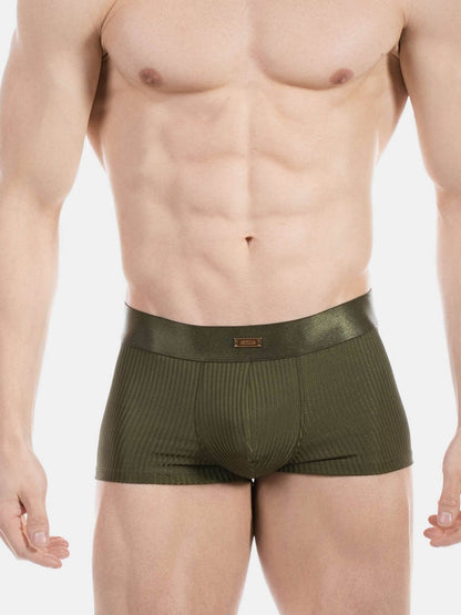 A close-up of a male model's lower torso wearing olive green ribbed boxer briefs against a plain light gray background.