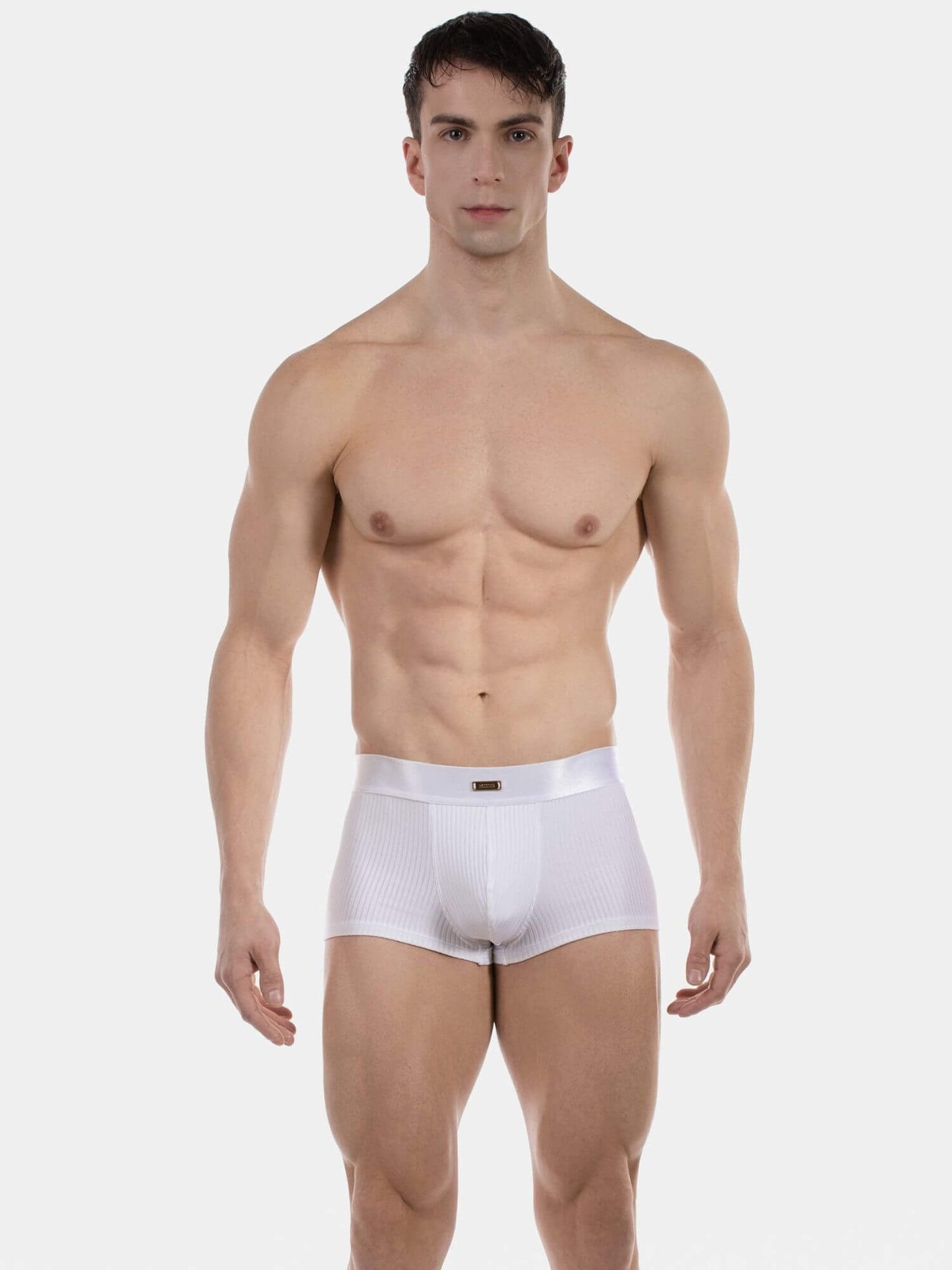 Man wearing white underwear on a plain background