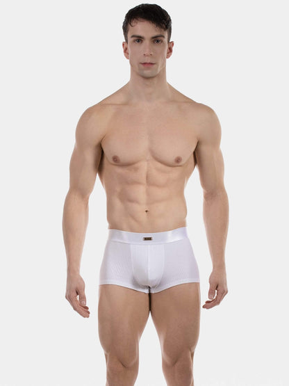 Man wearing white underwear on a plain background