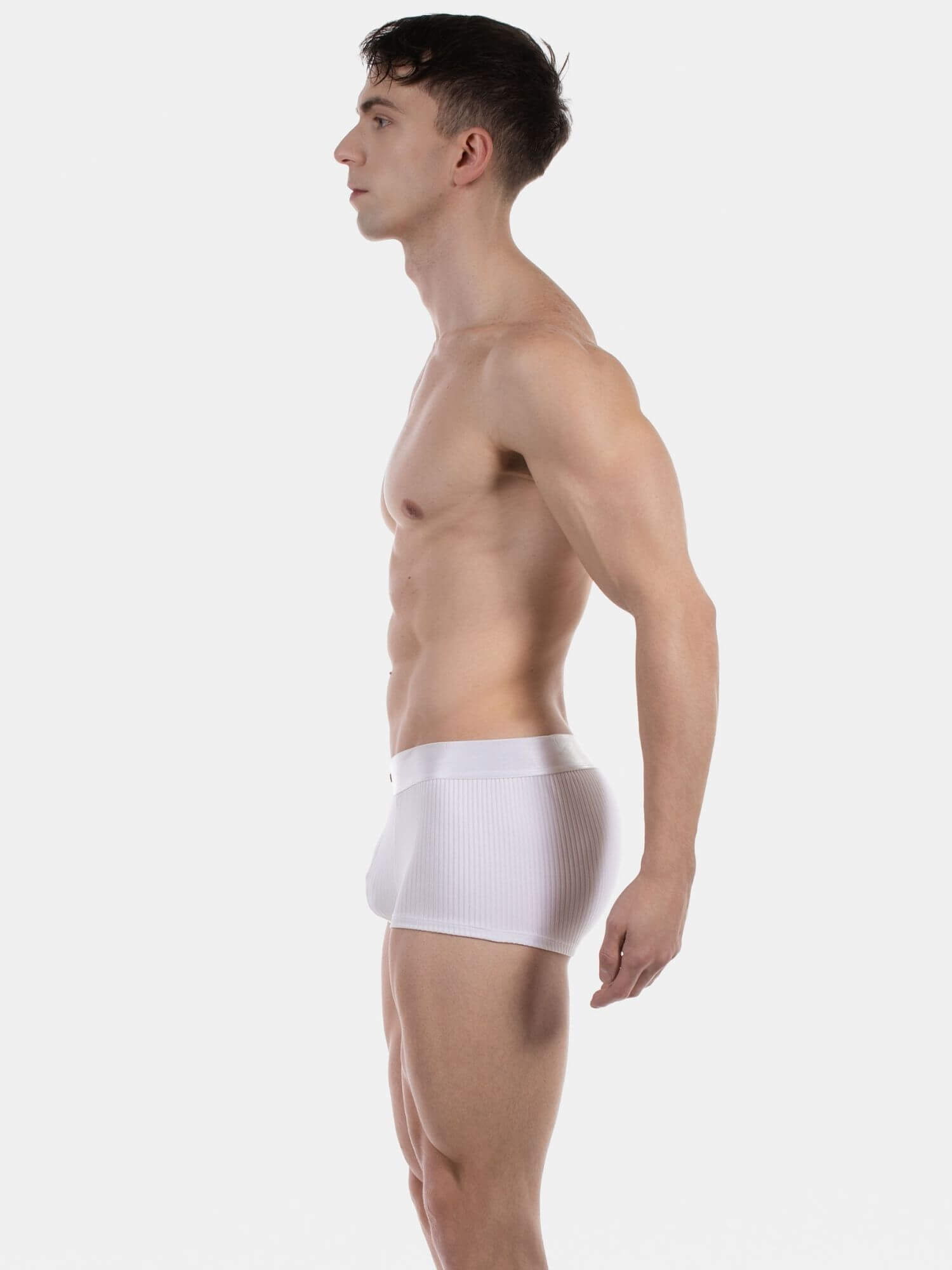 Man wearing a white underwear on a plain background