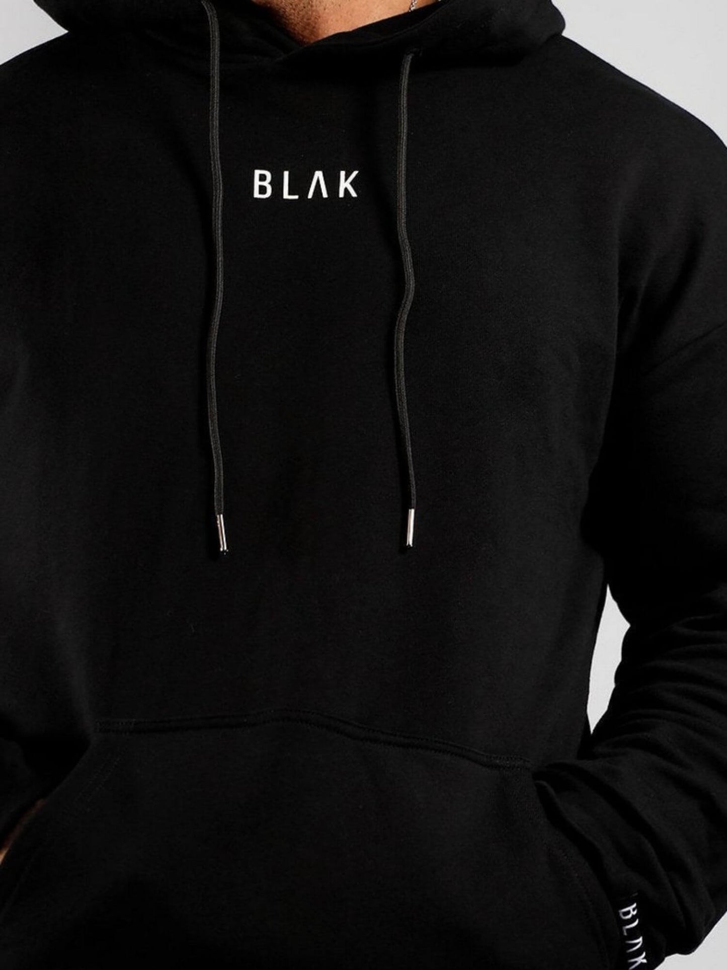 Black hoodie with 'BLAK' logo on a gray background