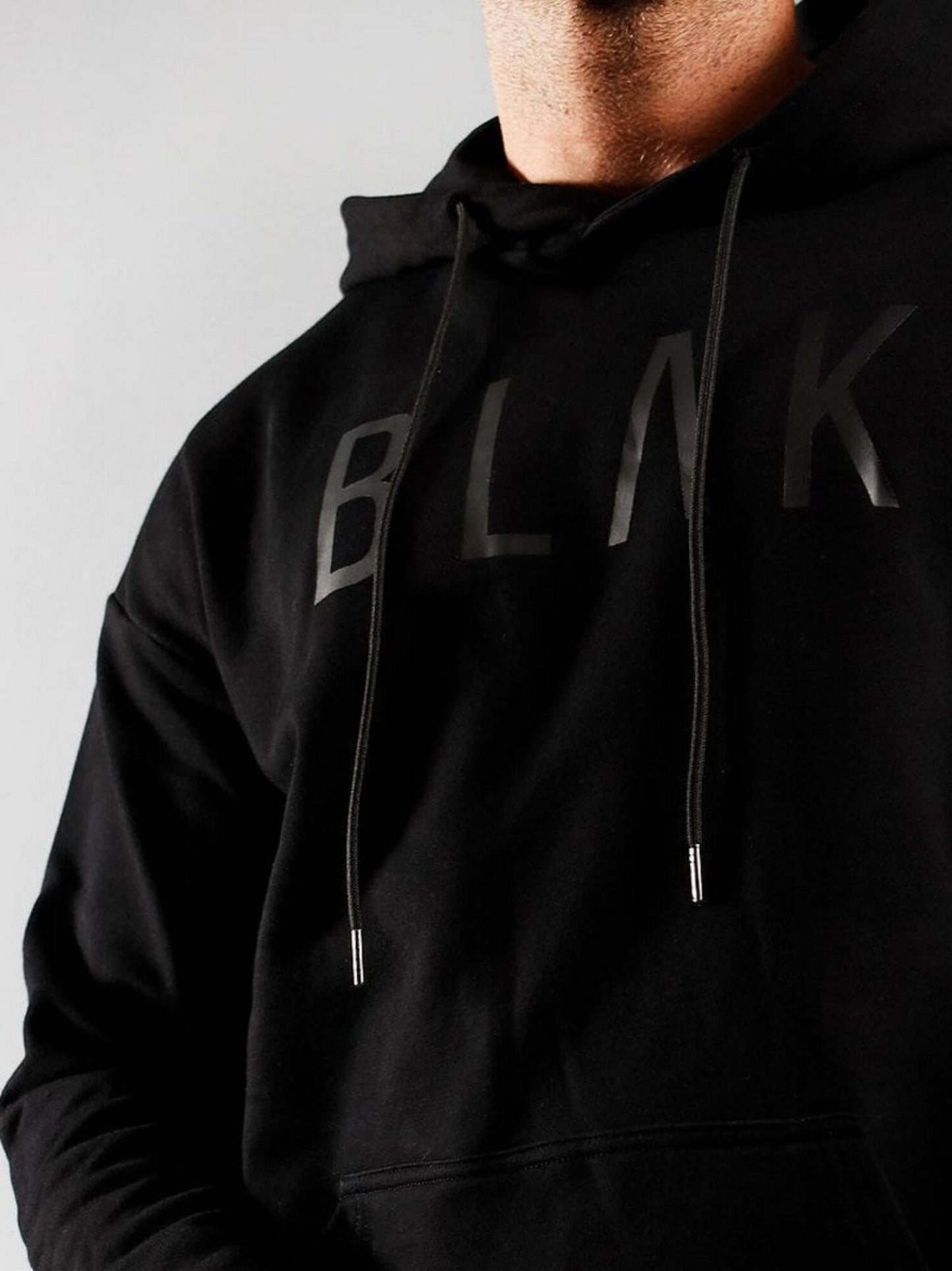 Black hoodie with 'BLAK' branding on a plain background