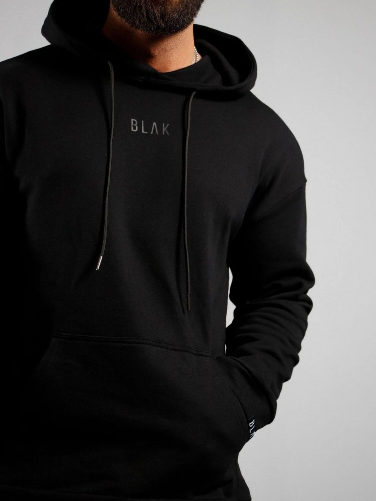 Black hoodie with 'BLAK' logo on a gray background