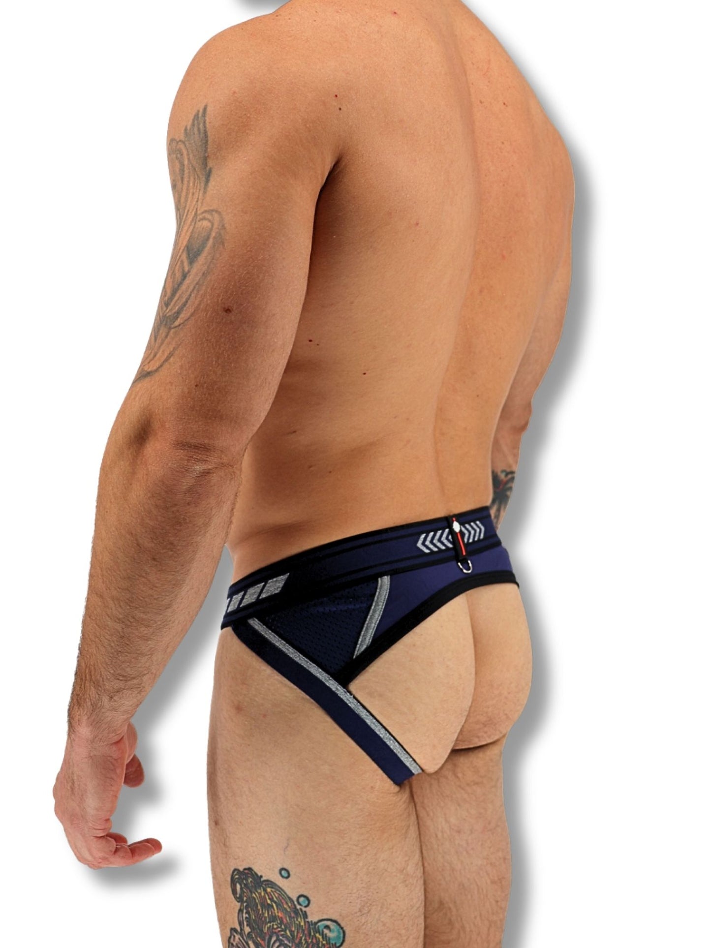 Man wearing a black and blue men's underwear with visible tattoos on a white background
