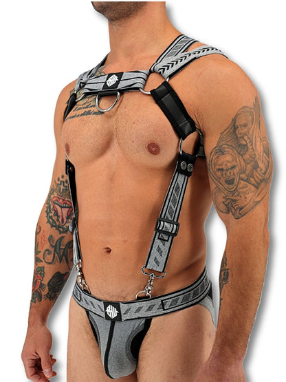 Man wearing a gray harness with intricate designs on a white background