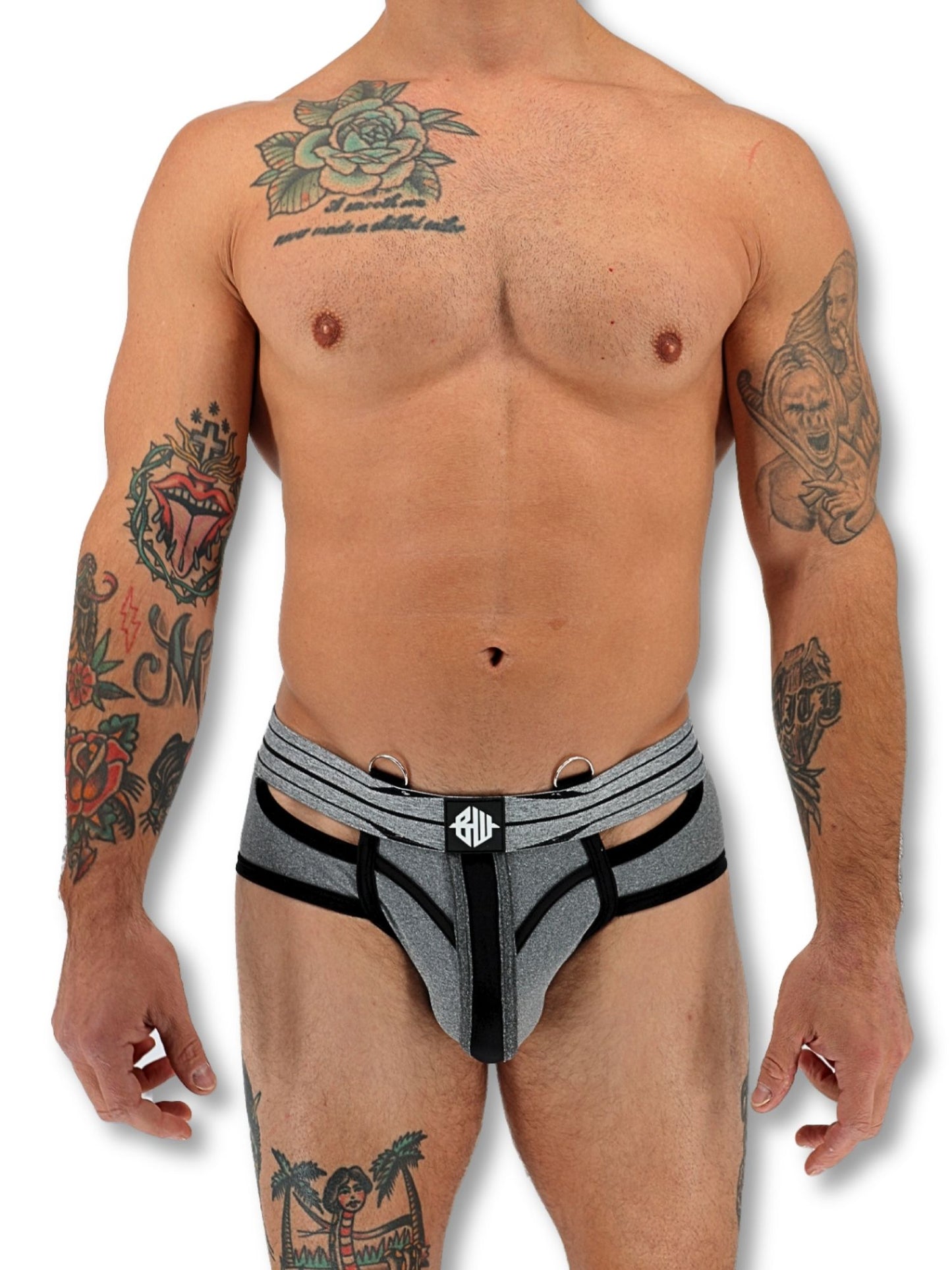 Man wearing gray and black underwear with tattoos on arms and chest.