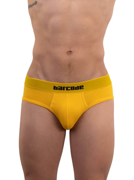 A model wearing a yellow cotton Barcode Berlin Helios backless brief with the brand's logo on the waistband.