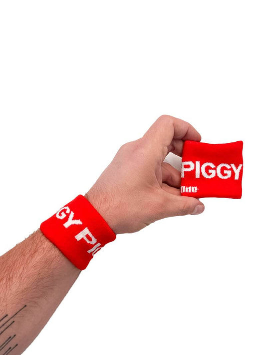 A hand holding two white wristbands with the text 'Top' written in black lettering and a black stripe design.