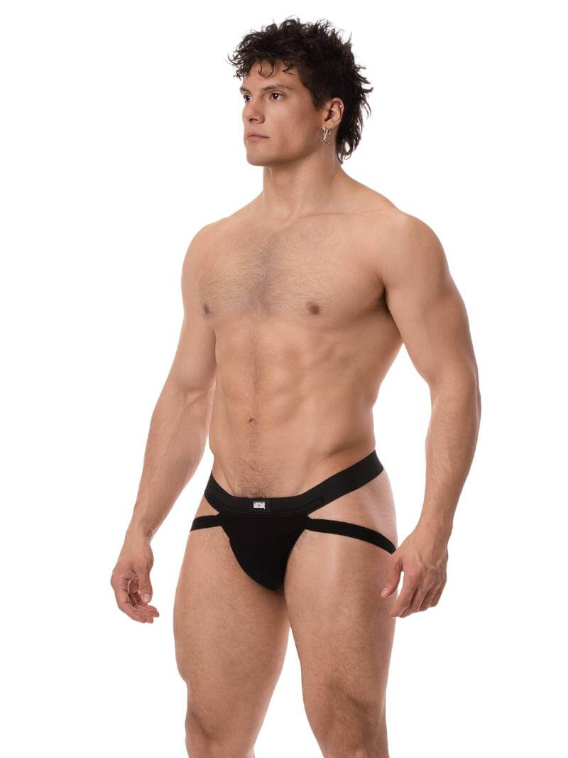 Man wearing a black men's jockstrap on a white background
