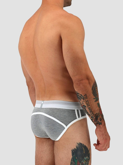 A man shown from the back wearing gray heathered briefs with white trim and a white waistband, against a light gray studio background.