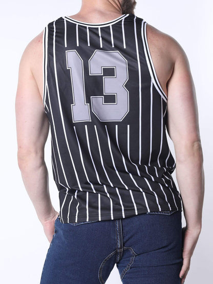 A man wearing a black and white pinstripe basketball jersey with the number 13 on the back, paired with dark blue jeans, shown from a rear three-quarter view against a white studio background.