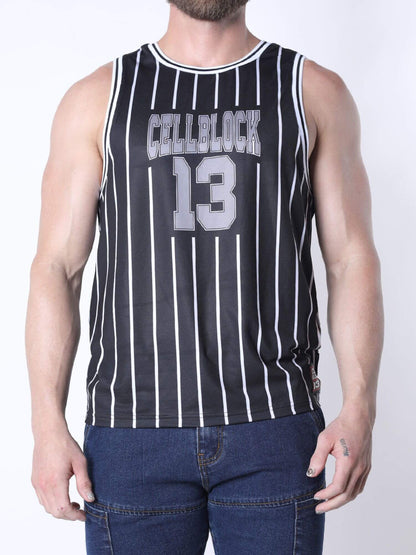 A man wearing a black sleeveless basketball jersey with white vertical pinstripes, featuring 'CELLBLOCK13' and the number '13' in gray varsity-style lettering on the front, paired with blue jeans against a light gray studio background.