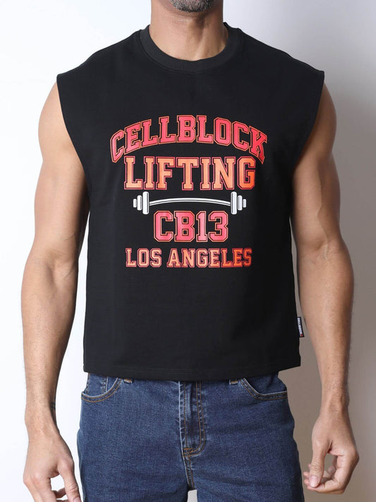 A man wearing a black sleeveless muscle tank top with a distressed red and white graphic that reads 'CELLBLOCK LIFTING CB13 LOS ANGELES' with a barbell design, paired with blue jeans against a plain light background.