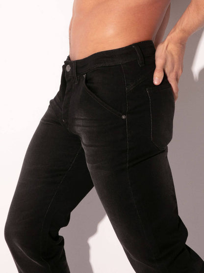 Black jeans worn by a person on a plain background