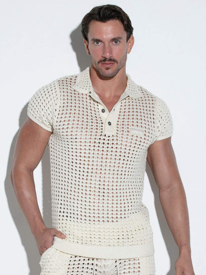 Man wearing a textured white outfit against a plain background