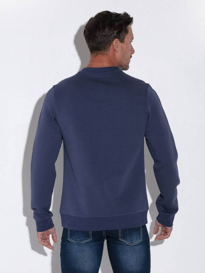 Man wearing a navy blue sweatshirt against a white background