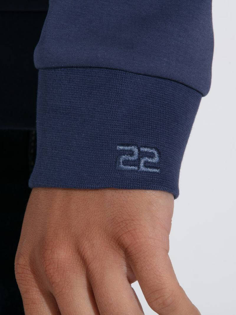 Navy blue sleeve with number 22 on a person's arm against a white background