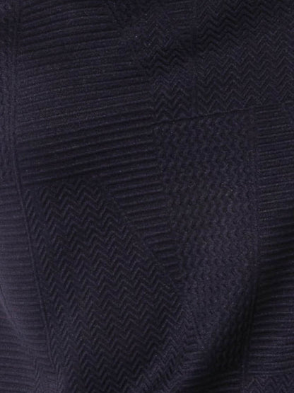 Close-up of a textured navy blue fabric with a subtle pattern
