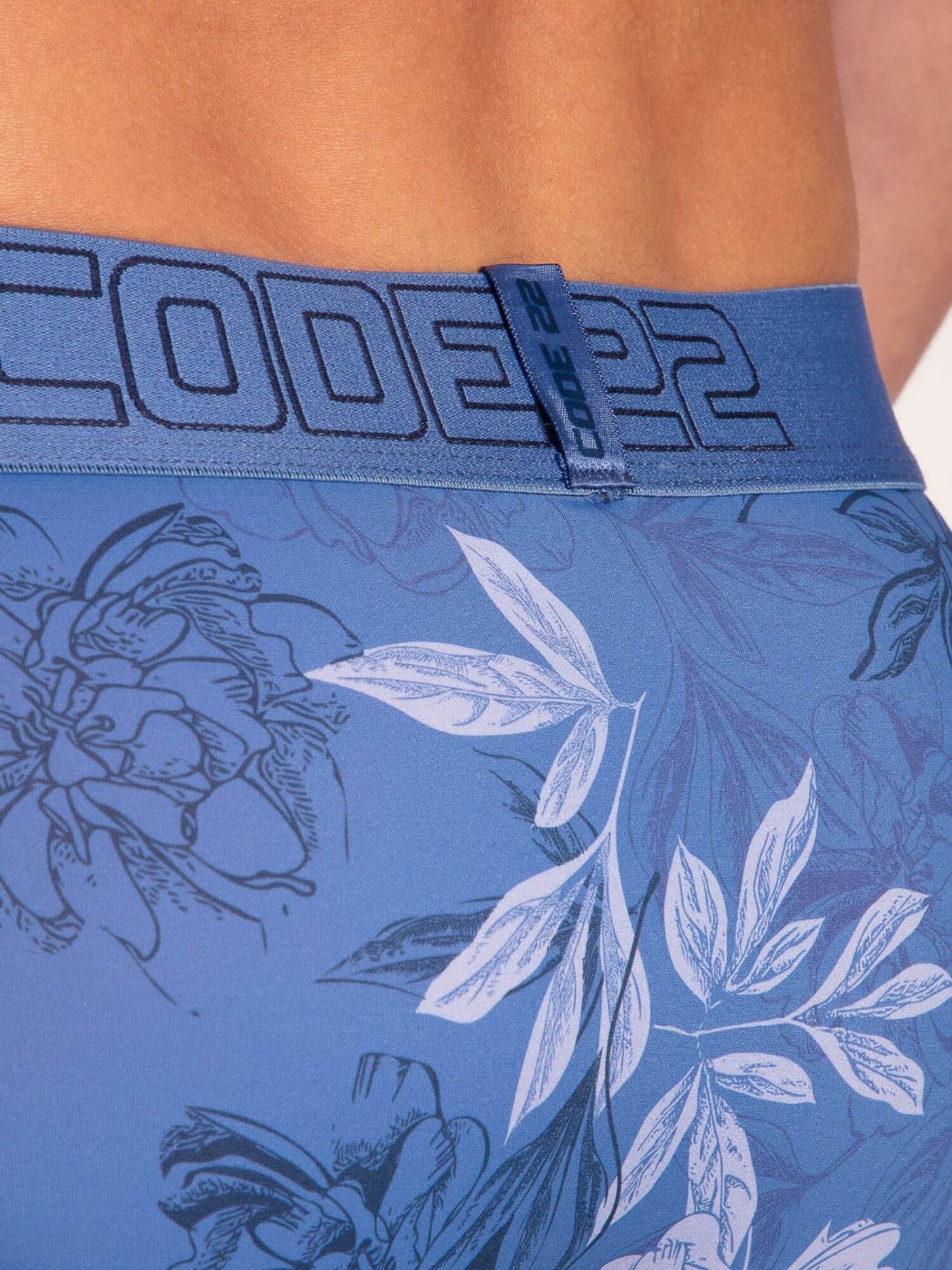 Blue briefs with floral pattern and brand logo on waistband