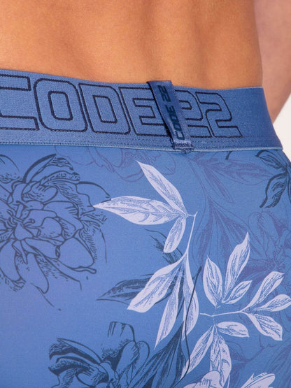 Blue briefs with floral pattern and brand logo on waistband