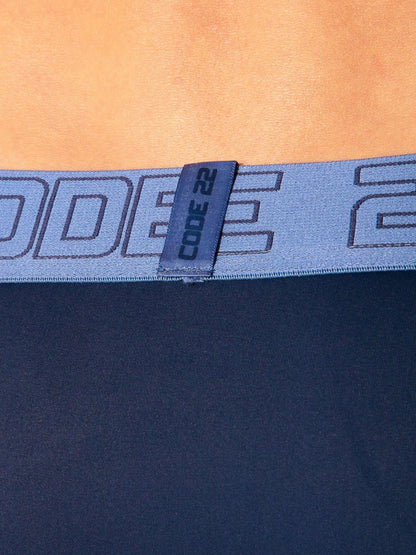 Close-up of a blue waistband with 'CODE 22' branding 