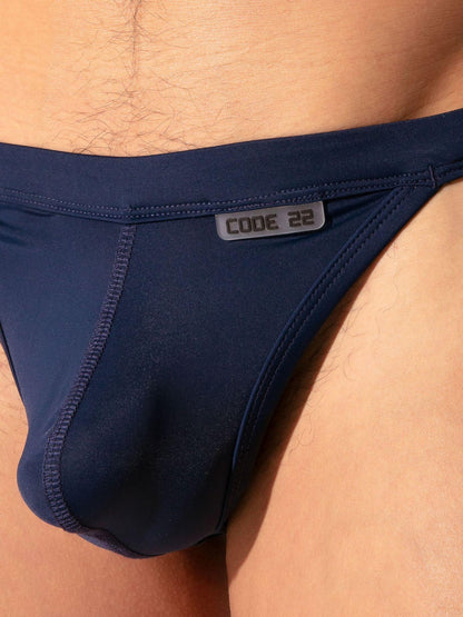 Navy blue men's underwear with 'CODE 22' label on a person wearing it.