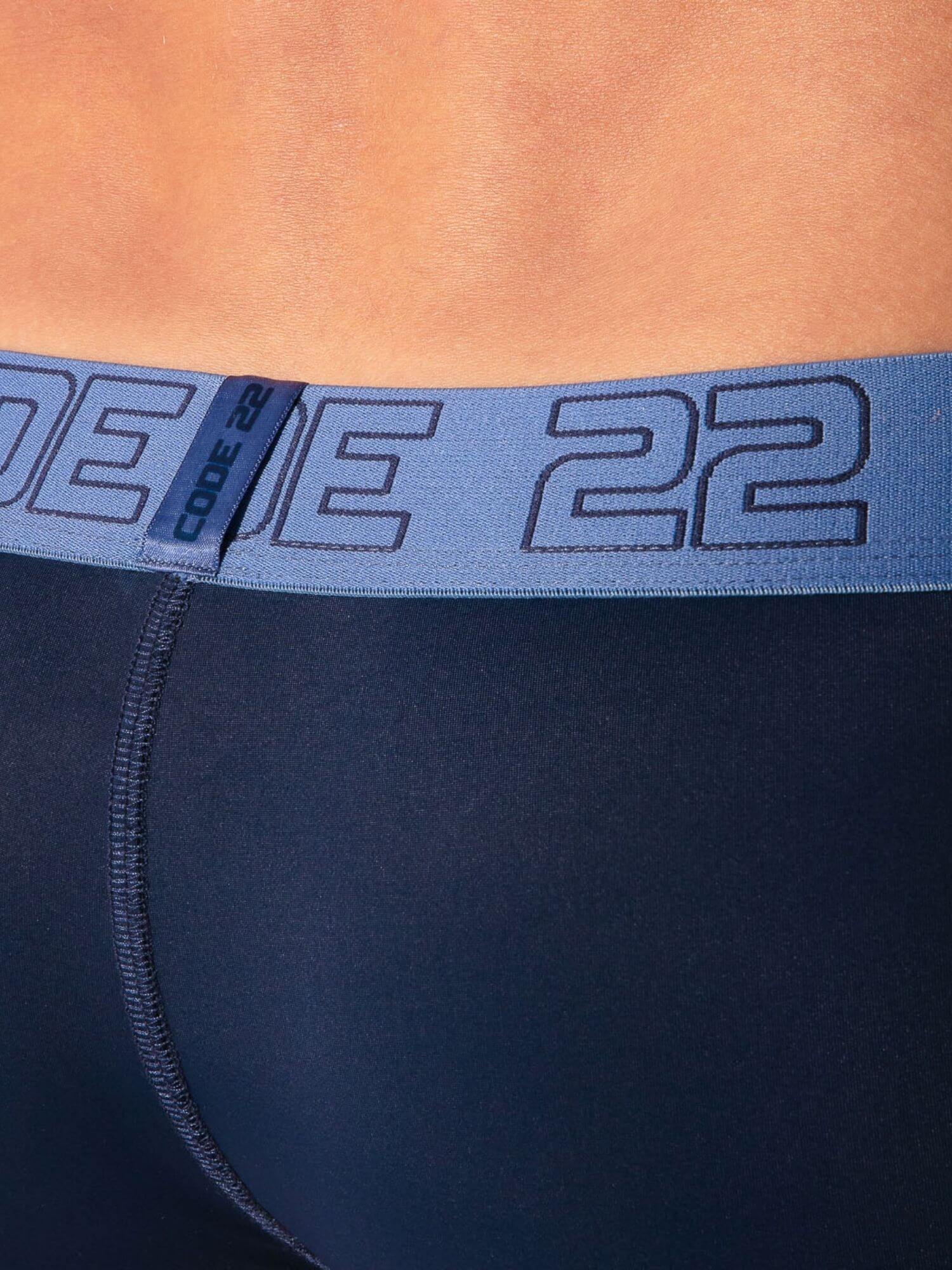 navy athletic shorts with a blue waistband displaying 'CODE 22' branding.