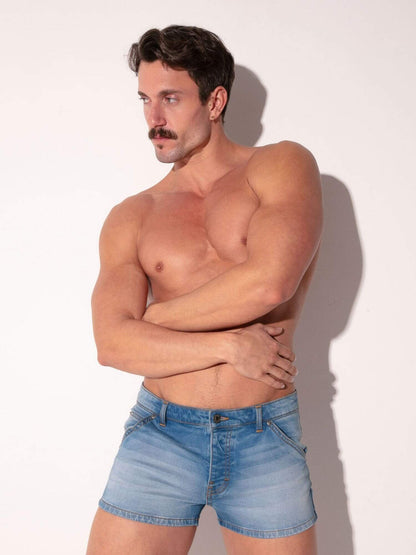 Man wearing light blue denim shorts against a white background