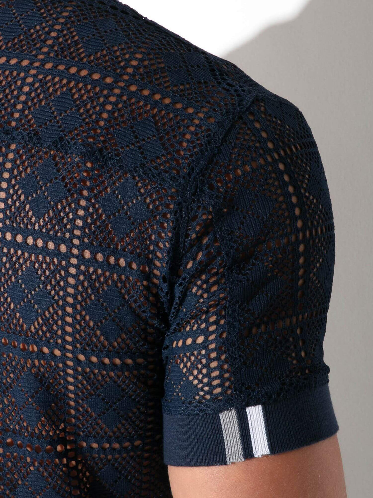 Close-up detail of CODE 22 Graphic Lace Polo Shirt in navy