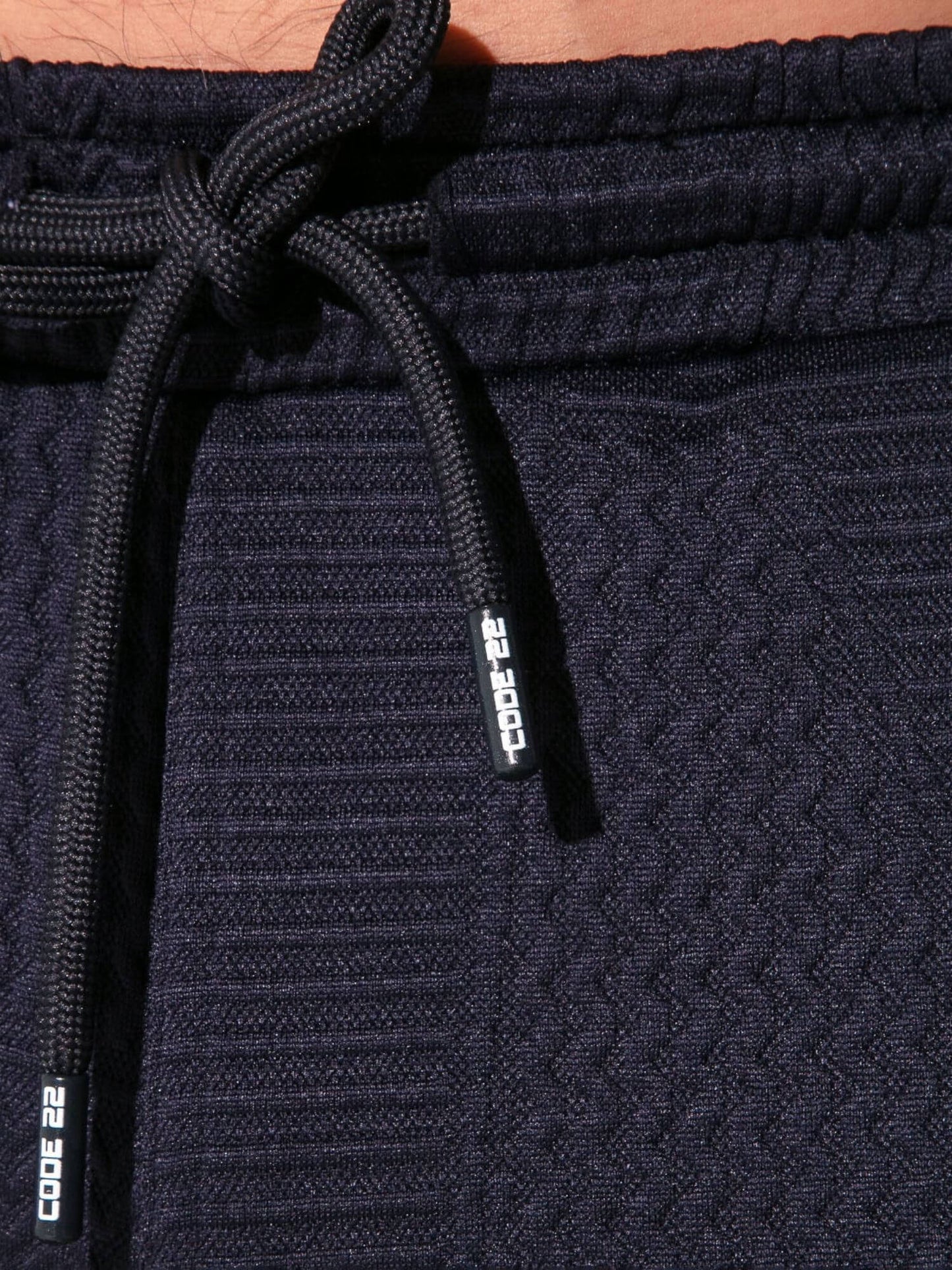 Navy blue jogger pants with drawstring and 'Code 22' branding on a matching tag.