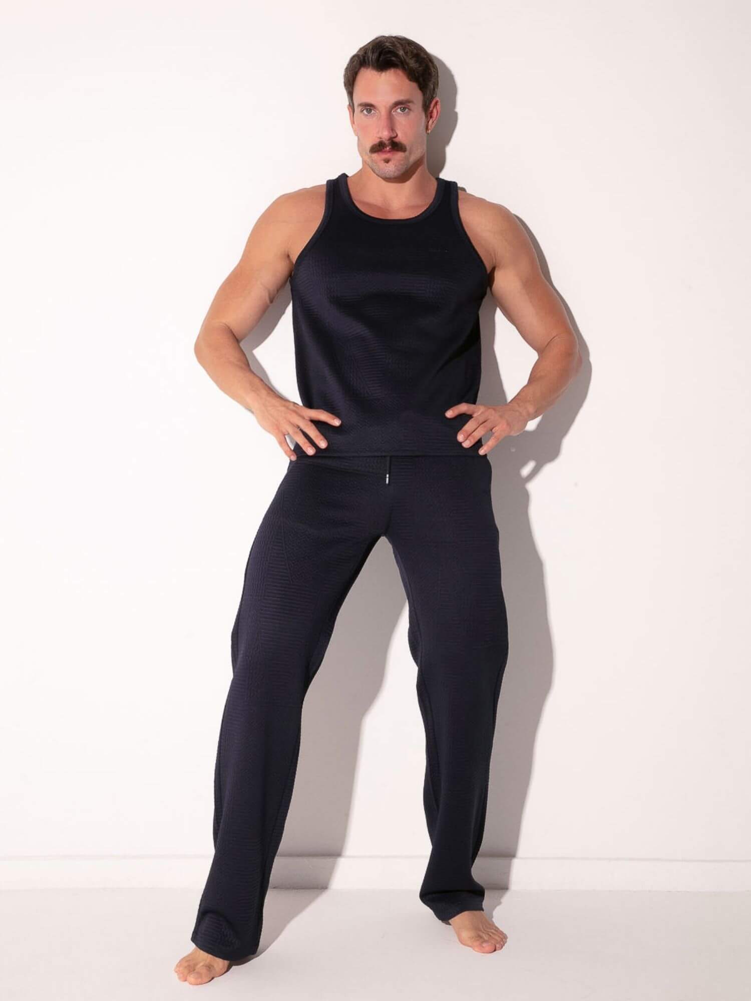 man wearing navy code 22 medley tank top and pants
