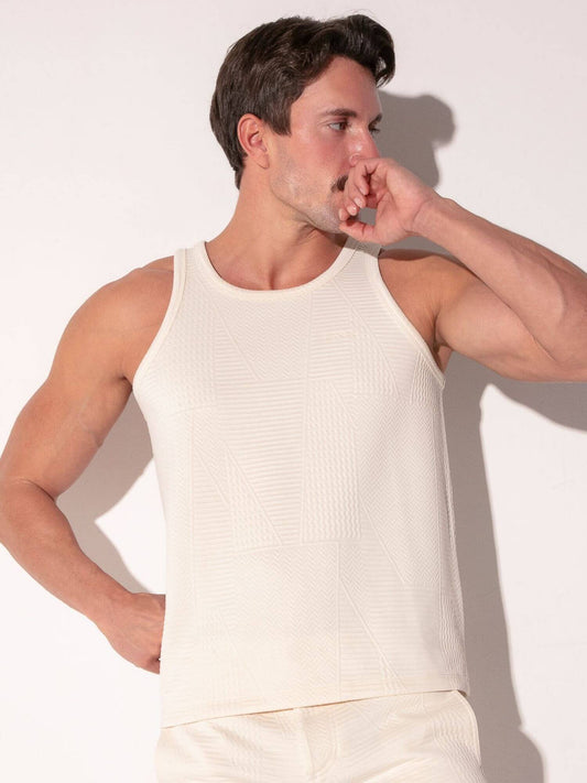 Man wearing a off-white tank top against a plain background