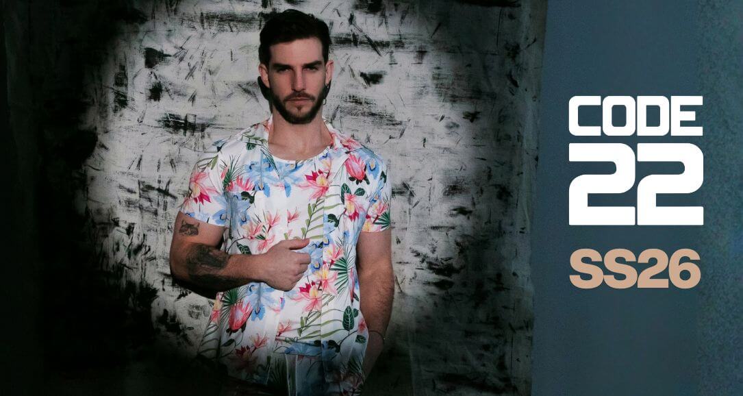 Man wearing a floral shirt with 'Code 22 SS26' branding on a dark background