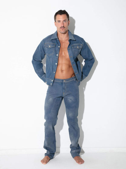 A man modeling a matching blue denim jacket and jeans set against a plain white studio background.