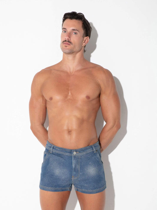 A shirtless man modeling blue denim shorts against a plain white studio background.