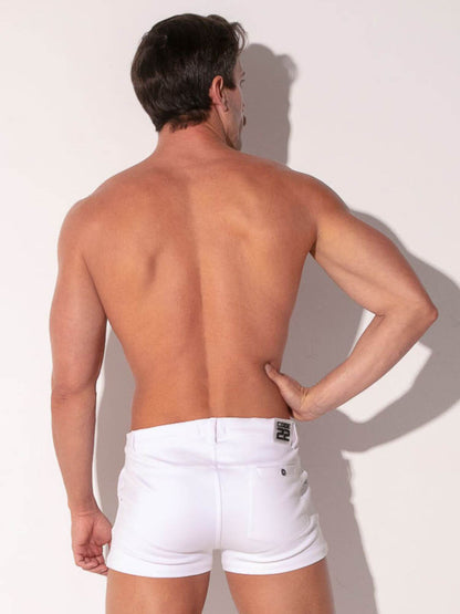 Man wearing white shorts against a plain background