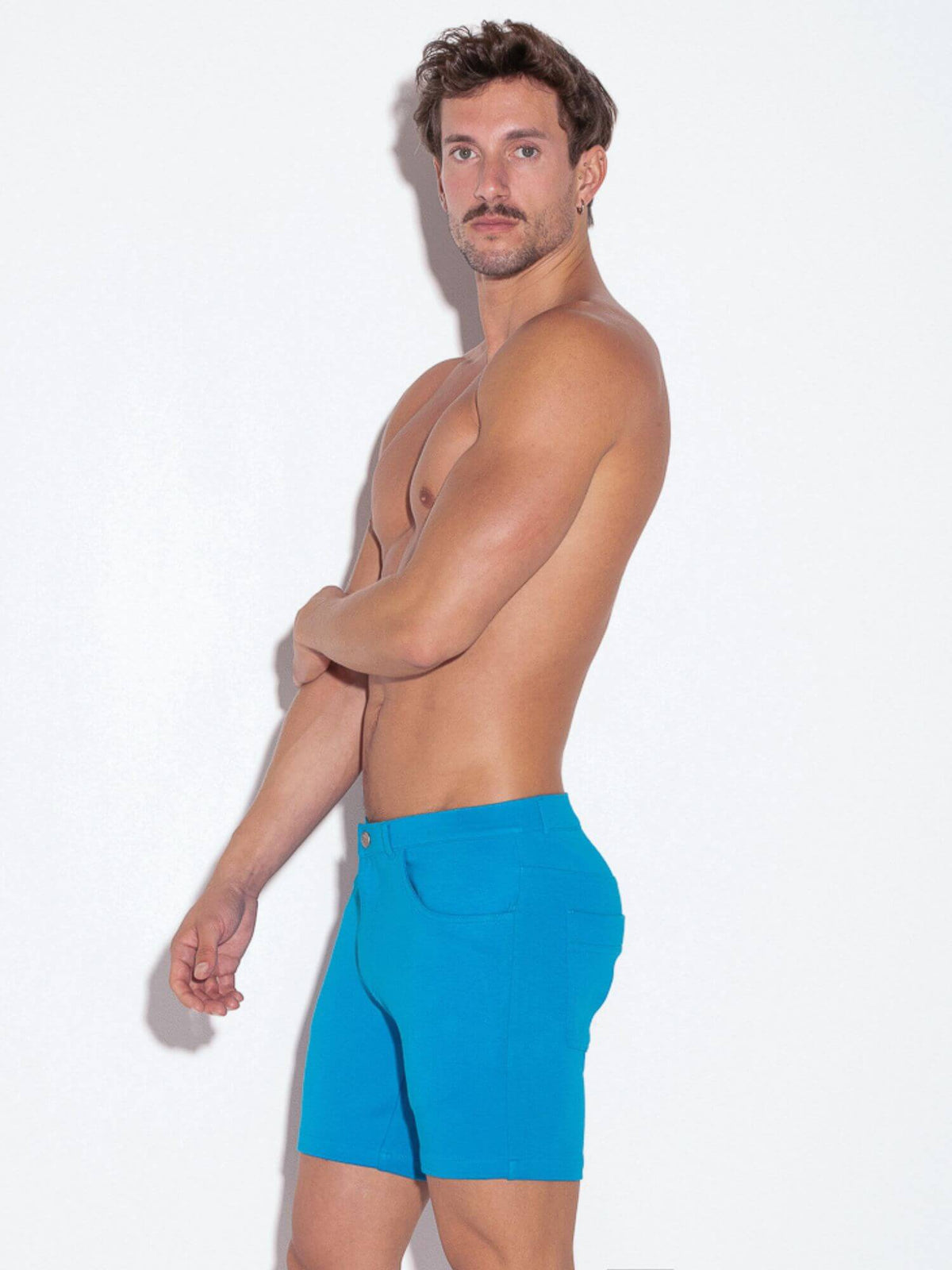 Man wearing blue shorts against a white background
